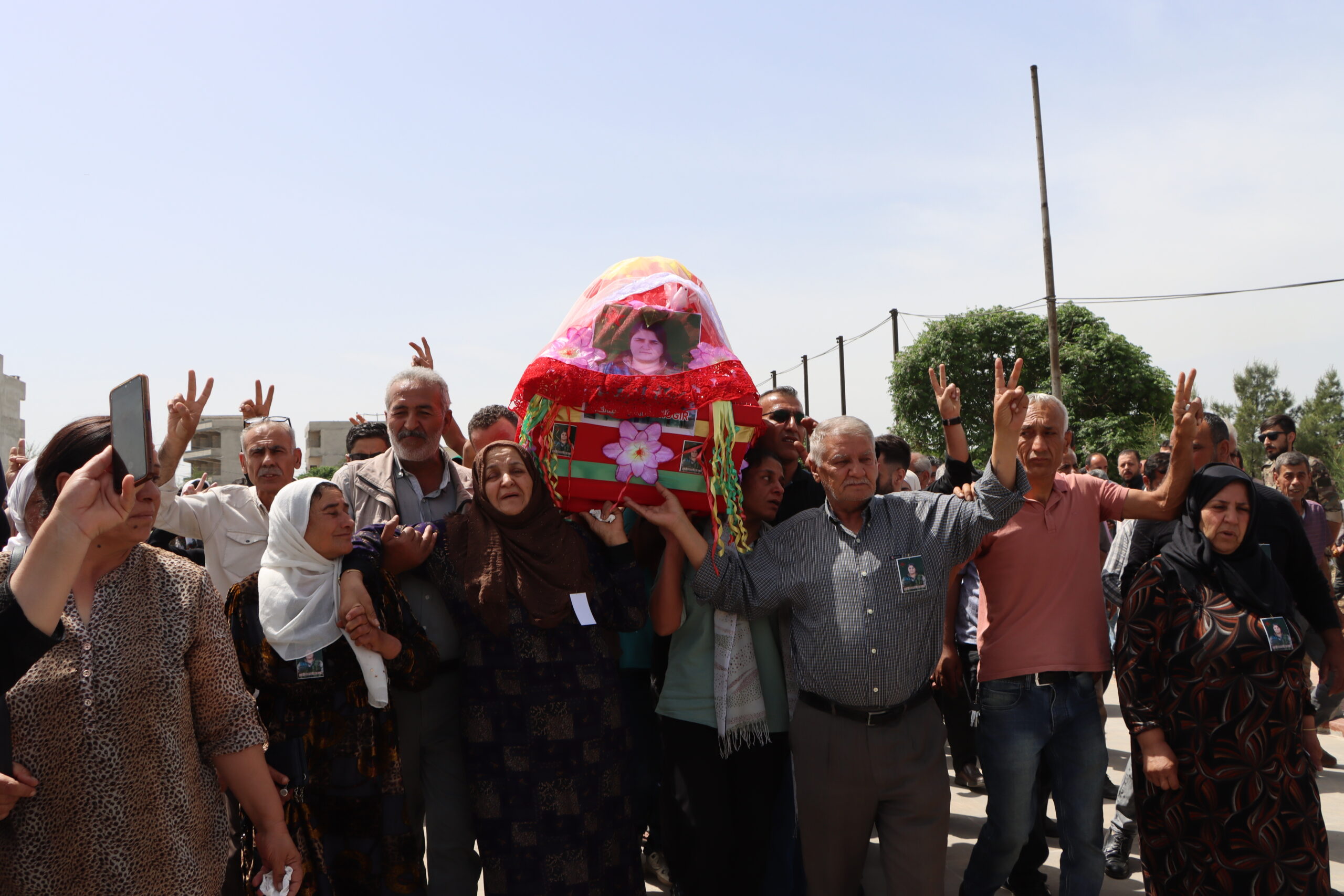 Hundreds of locals escort the body of the martyr Narvin Hoker in the city of Qamishli.