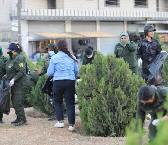 A Voluntary Clean-Up Campaign Carried Out by Women Fighters of the Women’s Protection Units and Internal Security Forces at Martyr Arîn Mîrkan Roundabout in Kobanê